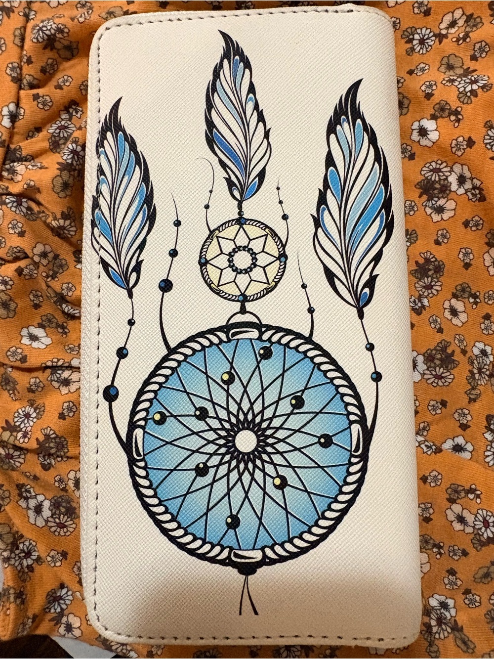 Dreamcatcher wallet blue and white with black inside.
